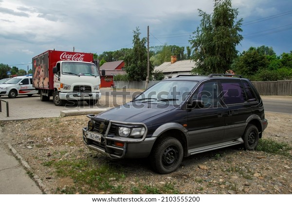 kazakhstan,\
Ust-Kamenogorsk, june 4, 2021: Coca-Cola truck. The Coca-Cola\
Company. Mitsubishi RVR. Urban\
cityscape