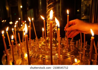 Kazan cathedral. Russian orthodox believer lights candles. Saint Petersburg. Russia. 