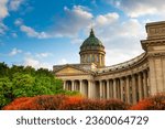 Kazan Cathedral in Saint Petersburg, Russia. Autumn cityscape with red and green trees at sunset