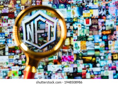 Kazan, Russia - April 03, 2021: NFT (non-fungible token) symbol under magnifying glass on screen laptop with blurred Beeple digital art EVERYDAYS: THE FIRST 5000 DAYS.