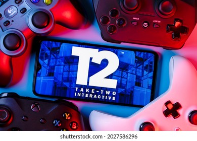 Kazan, Russia - August 19, 2021:  Take-Two Interactive Software, Inc. is an American video game holding company. A smartphone with the Take-Two logo on the screen surrounded by gamepads.