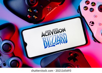 Kazan, Russia - August 7, 2021:  Activision Blizzard, Inc. is an American video game holding company. A smartphone with the Activision Blizzard logo on the screen surrounded by gamepads.