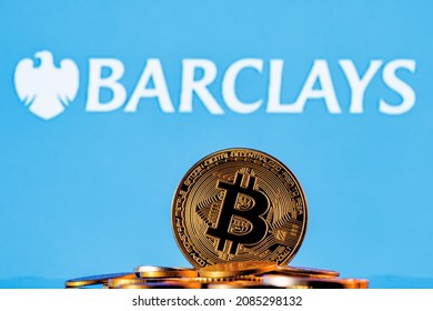 Kazan, Russia - Dec 03, 2021: Golden Bitcoin In A Pile Of Coins On The Background Of Barclays Bank Logo