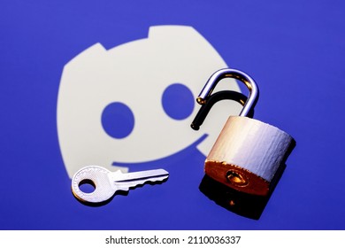 Kazan, Russia - Jan 20, 2022: An Open Security Lock And Key On The Background Of The Discord Social Gaming Platform Logo In The Mirror Reflection.