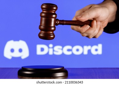 Kazan, Russia - Jan 20, 2022: Gavel In Hand Against The Background Of Discord Social Gaming Platform Logo. The Concept Of The Trial.