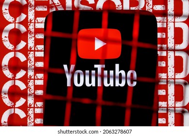 Kazan, Russia - Oct 24, 2021: Youtube Logo On The Smartphone Screen Behind The Bars On The Background With The Inscription Censored. The Concept Of Youtube Censorship And Prohibition.