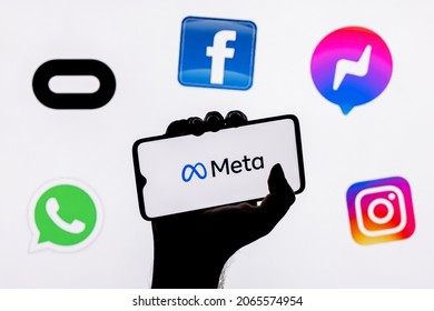 Kazan, Russia - Oct 28, 2021: Facebook changes its name to Meta. Smartphone with Meta logo on the background on logos of products owned by facebook metaverse.