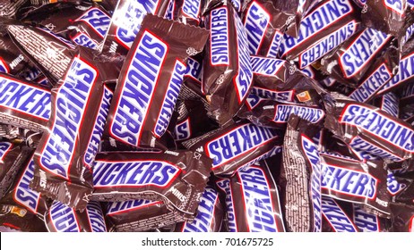 Kazan, Russian Federation - Jun 30, 2017: Snickers minis candy bars heap. Full Frame. Snickers bar is a chocolate bar with caramel and peanuts, manufactured by Mars, Incorporated.