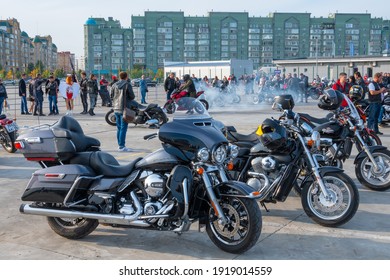Kazan, Russia-September 26, 2020: Bikers next to their motorcycles in the parking lot during a meeting of bikers before a joint trip around the city, in the background, a biker makes a burnout