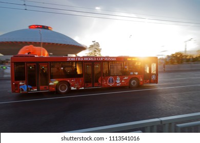 Kazan, Tatarstan, Russia - June 11, 2018. Bus with football championship symbols rides down the street in the rays of the setting sun