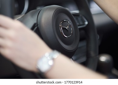 KAZAN, TATARSTAN, RUSSIA - NOVEMBER 2018: Female hands on Mazda steering wheel.