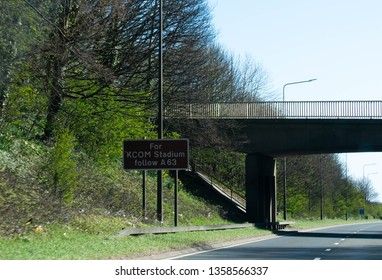 KCOM road sign in Kingston upon Hull, city of Culture 2017. Kcom football and sports ground sign on motorway road with bridge  - Powered by Shutterstock