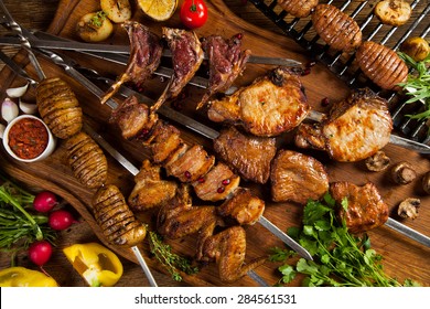 Kebab, chicken wings, potato on skewer. bbq meat, top view.
Grilled meat skewers, shish kebab on wooden background - Shutterstock ID 284561531