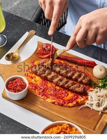kebab on flatbread with tomato and pepper served on a wooden cutting board