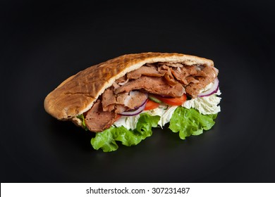 Kebab In Pita Bread Isolated On Black Background