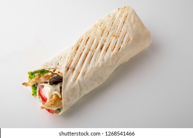 Kebab, pita, gyros, shaurma, wrap sandwich stuffed with sausages from minced meat, french fries, fresh vegetables, sauce. Street food. Takeaway food. - Shutterstock ID 1268541466