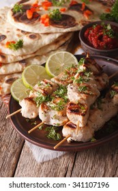 Kebabs Chicken Tikka On Skewers Close-up On A Plate And Naan Flat Bread. Vertical
