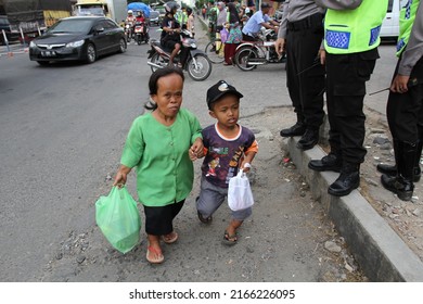 Kebumen, Indonesia - July, 2014: Midgets walk near Gombong traditional market, Kebumen, Indonesia.