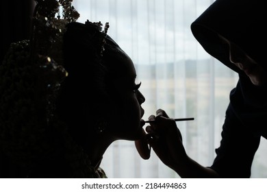 Kebumen, Indonesia - March, 2017: Silhouette Of A Javanese Bride Being Made Up By A Make Up Artist.