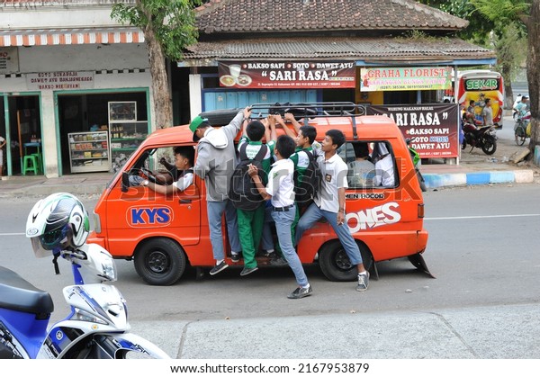 Kebumen,\
Indonesia - October, 2014: Students take an overloaded public\
transport near the Kebumen bus\
station.
