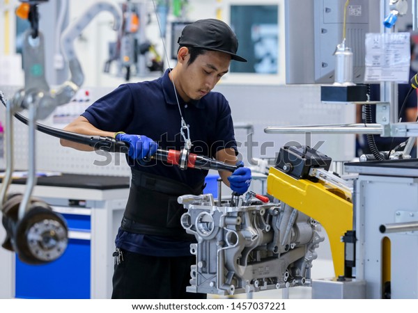 KEDAH, MALAYSIA - JULY 04, 2019 :\
Workers at engine assembly plant. Catering for both the domestic\
and export markets. Automotive &\
technology.