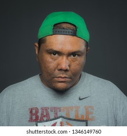 Kedah, Malaysia - June 25 2018 : A Young Malay Man Wearing Green Cap And T Shirt Brand 