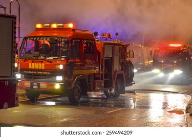 Kedah, Malaysia - March 8, 2015 : A supermarket was burned terribly and almost 10 Fireman vehicles come to rescue and stop the fire. The water was supplied from one kilometer away by Fireman Hose.