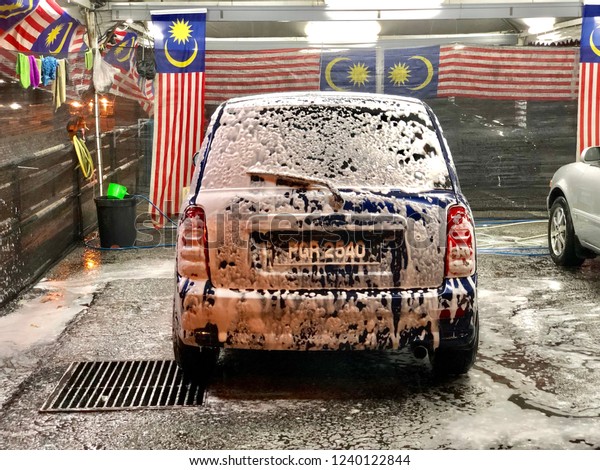 Kedah,Malaysia :
25-11-2018 : Bubble car washing in Malaysia when in the
night,background with Malaysia
Flag.