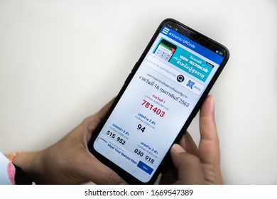 Kedah,Malaysia - 29-02-2020 : hand holding mobile phone with thailand lottery application which results come out every month. - Shutterstock ID 1669547389