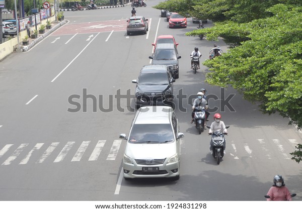 Kediri, East Java, Indonesia -\
February 20th, 2021: Vehicle on the road with a natural\
background