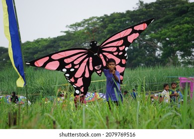 Kediri, East Java, Indonesia - November 21st, 2021 : The Participant Of The Indonesian Kites Festival And Their Kite With Butterfly Shape