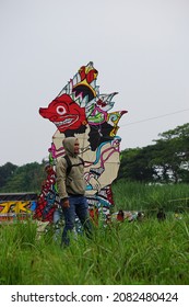 Kediri, East Java, Indonesia - November 21st, 2021 : The Participant Of The Indonesian Kites Festival And Their Kite With Wayang Shape