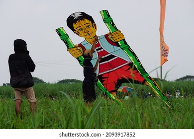 Kediri, East Java, Indonesia - November 21st, 2021 : The Participant Of The Indonesian Kites Festival And Their Kite With Human Shape