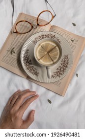 Kediri, Indonesia - March 2021: A Cup Of Lemon Tea On Old Book From ‘The Great Gatsby By F.Scott Fitzgerald’ And On White Sheet. Aesthetic Concept.