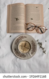 Kediri, Indonesia - March 2021: A Cup Of Lemon Tea On White Sheet With A Book From ‘The Great Gatsby By F.Scott Fitzgerald’ Aesthetic, Reading Time Concept.