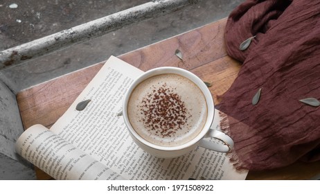 Kediri, Indonesia - May 2021: A Cup Of Cappuccino On A Page Of Book From “The Great Gatsby By F. Scott Fitzgerald
