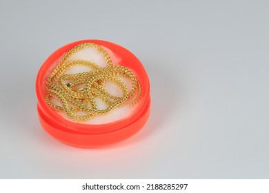 A Keel Pattern Gold Necklace In The Chinese Style Red Box Isolated On White Background.