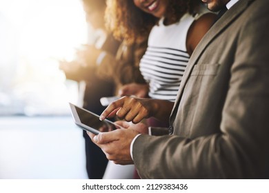 Keep All Your Information In One Place. Cropped Shot Of Businesspeople Using A Digital Tablet Together.