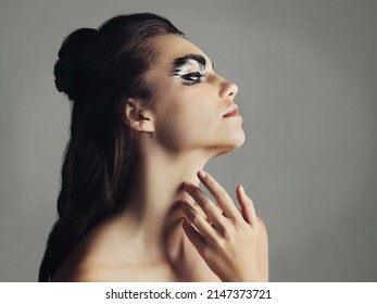 Keep It Appealing To The Eye. Studio Shot Of An Attractive Young Woman Wearing Bold Eye Makeup.