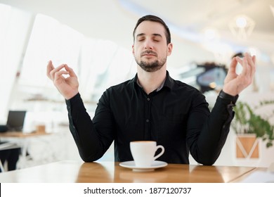 Keep Calm And Drink A Cup Of Good Espresso. Man Is Meditating Because Due To The Large Amount Of Caffeine, He Had A Panic Attack. Coffee Shop On Background. Stylish Man.