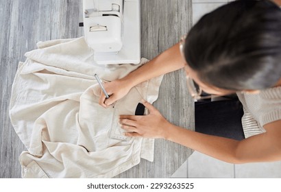 Keep calm and sew on. High angle shot of a young woman designing a garment in her workshop. - Powered by Shutterstock