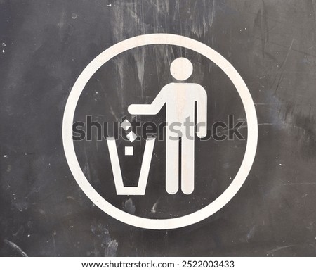 Keep clean, do not litter, or throw trashes in trash bin white icon sign  isolated on horizontal grunge dark gray colored surface background.
