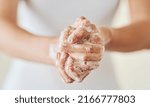 Keep clean and safe from germs. Closeup shot of a woman washing her hands with soap.