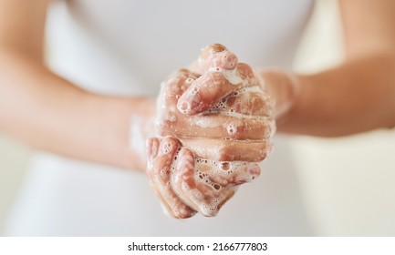 Keep clean and safe from germs. Closeup shot of a woman washing her hands with soap.