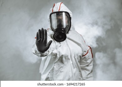 keep the distance, stop to coronavirus. disinfector male in gas-mask and protective suit disinfect contaminated areas full of bacterias. quarantine time - Shutterstock ID 1694217265