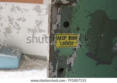 Keep door locked sign in abandoned hospital building
