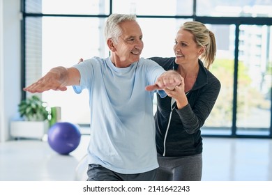 Keep flexible, youre doing good. Cropped shot of a friendly female physiotherapist helping her senior patient with his exercises. - Powered by Shutterstock