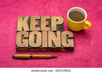 Keep going motivation word abstract in vintage letterpress wood type blocks with a cup of coffee, determination, persistence and tenacity concept
