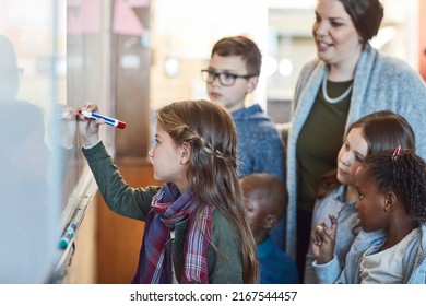 Keep Going, You Doing A Great Job. Cropped Shot Of An Elementary School Girl Writing On A Whiteboard In The Classroom.