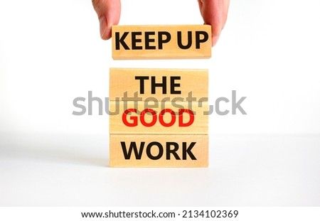 Keep up the good work symbol. Concept words Keep up the good work on wooden blocks. Businessman hand. Beautiful white table white background. Keep up the good work business concept. Copy space.